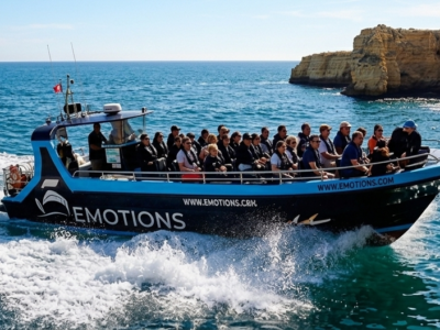 barco rápido con pasajeros navegando por la costa del Algarve cerca de Benagil