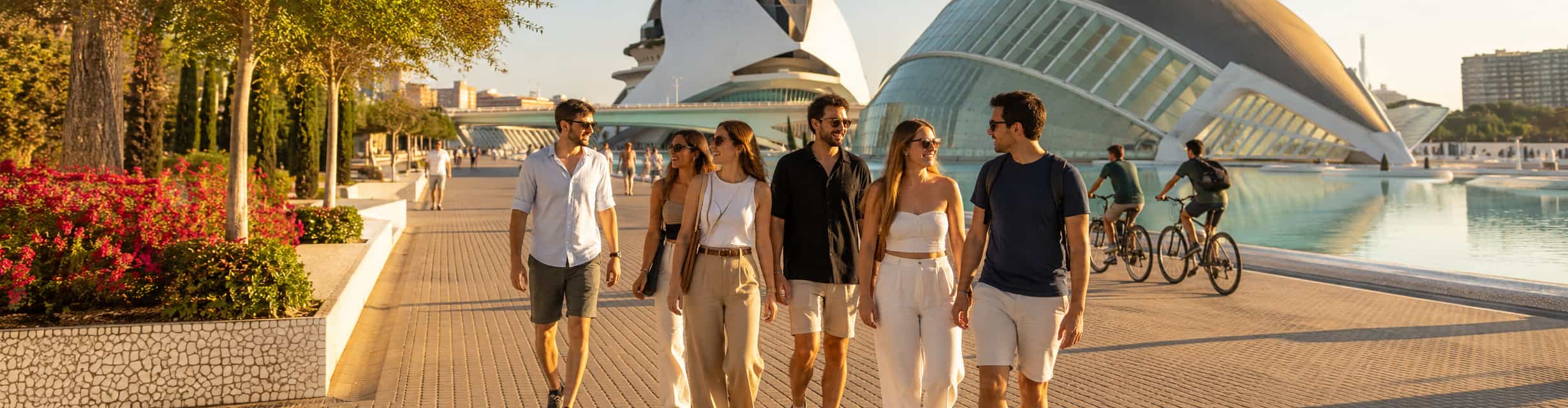 Grupo de viajeros paseando por la Ciudad de las Artes y las Ciencias en Valencia al atardecer · TiToTravel